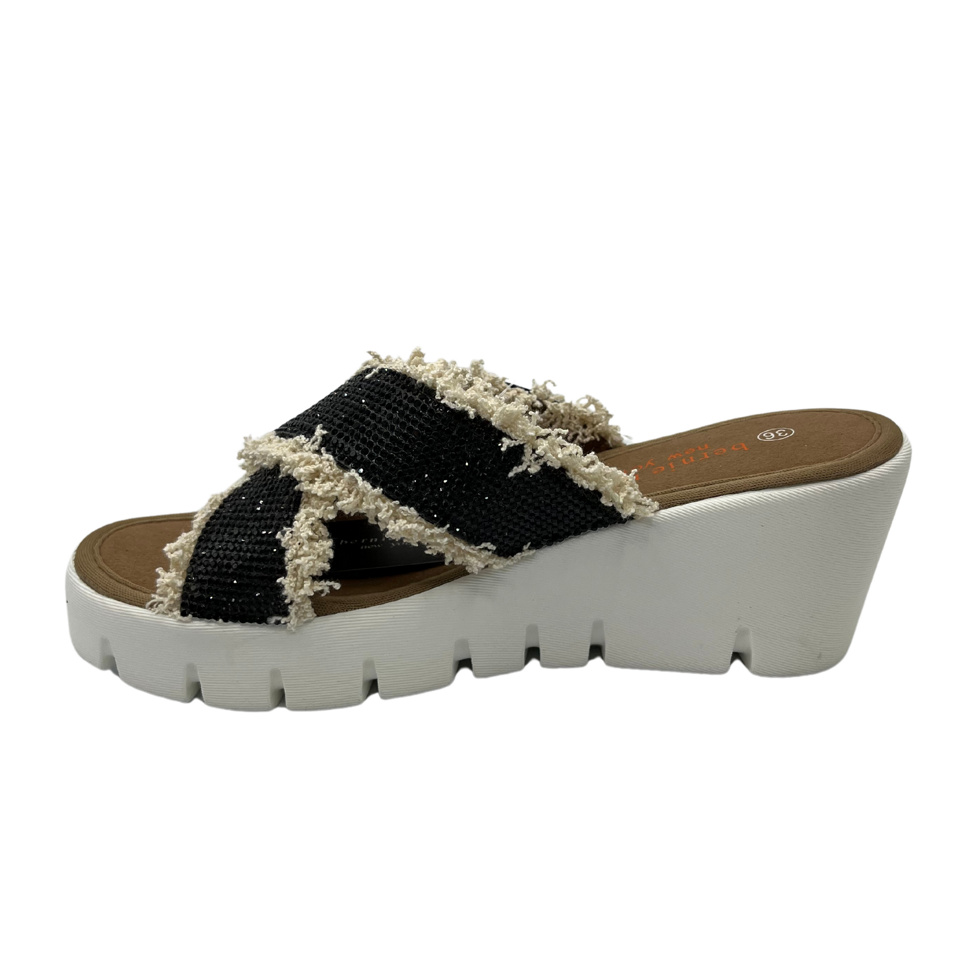 Left facing view of black rhinestone strapped sandals with fringe detail and white wedge heel