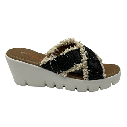 Right facing view of black rhinestone strapped sandals with fringe detail and white wedge heel