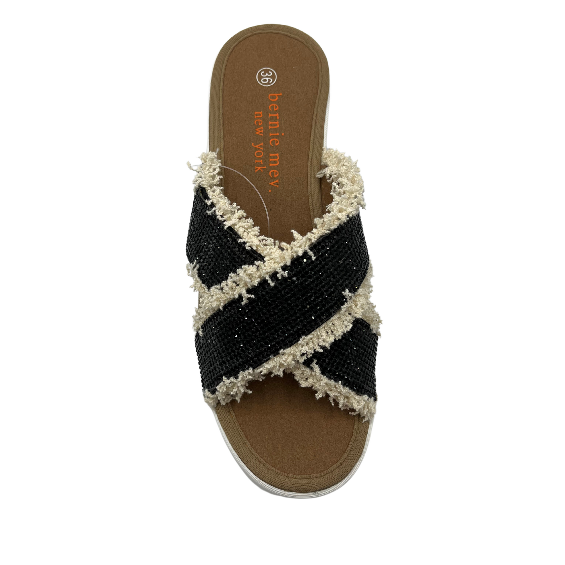 Top view of black rhinestone strapped sandals with fringe detail and white wedge heel