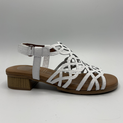 White sandal with brown sole on a gray background