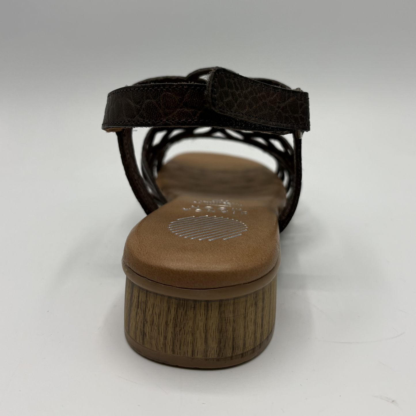 Brown sandal with a textured sole on a white background