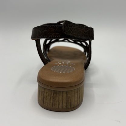 Brown sandal with a textured sole on a white background