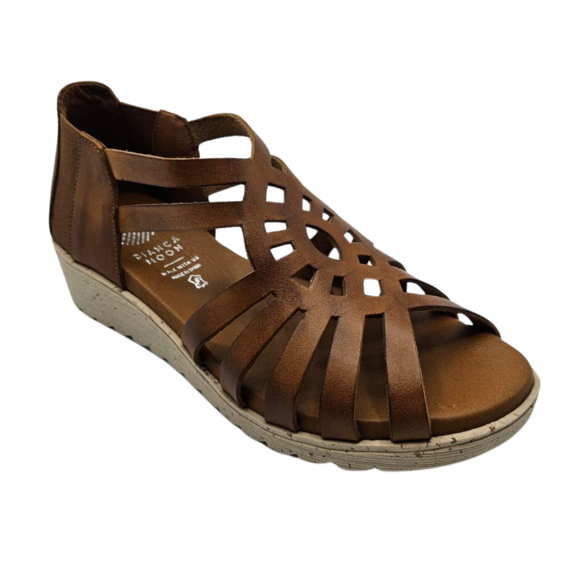 45 degree angled view of tan leather sandal with slight wedge heel and cutout design on upper.