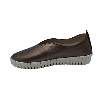 Left facing view of pewter leather slip on shoe with white rubber outsole