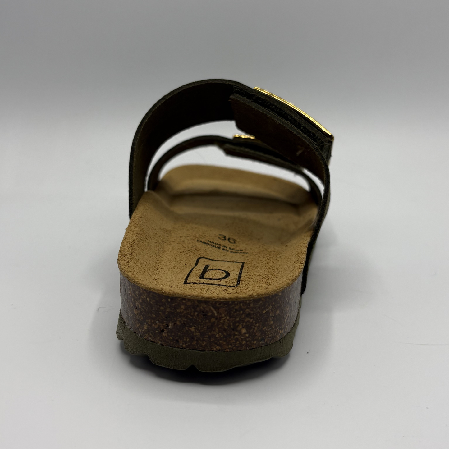 Khaki sandal with cork sole on a gray background