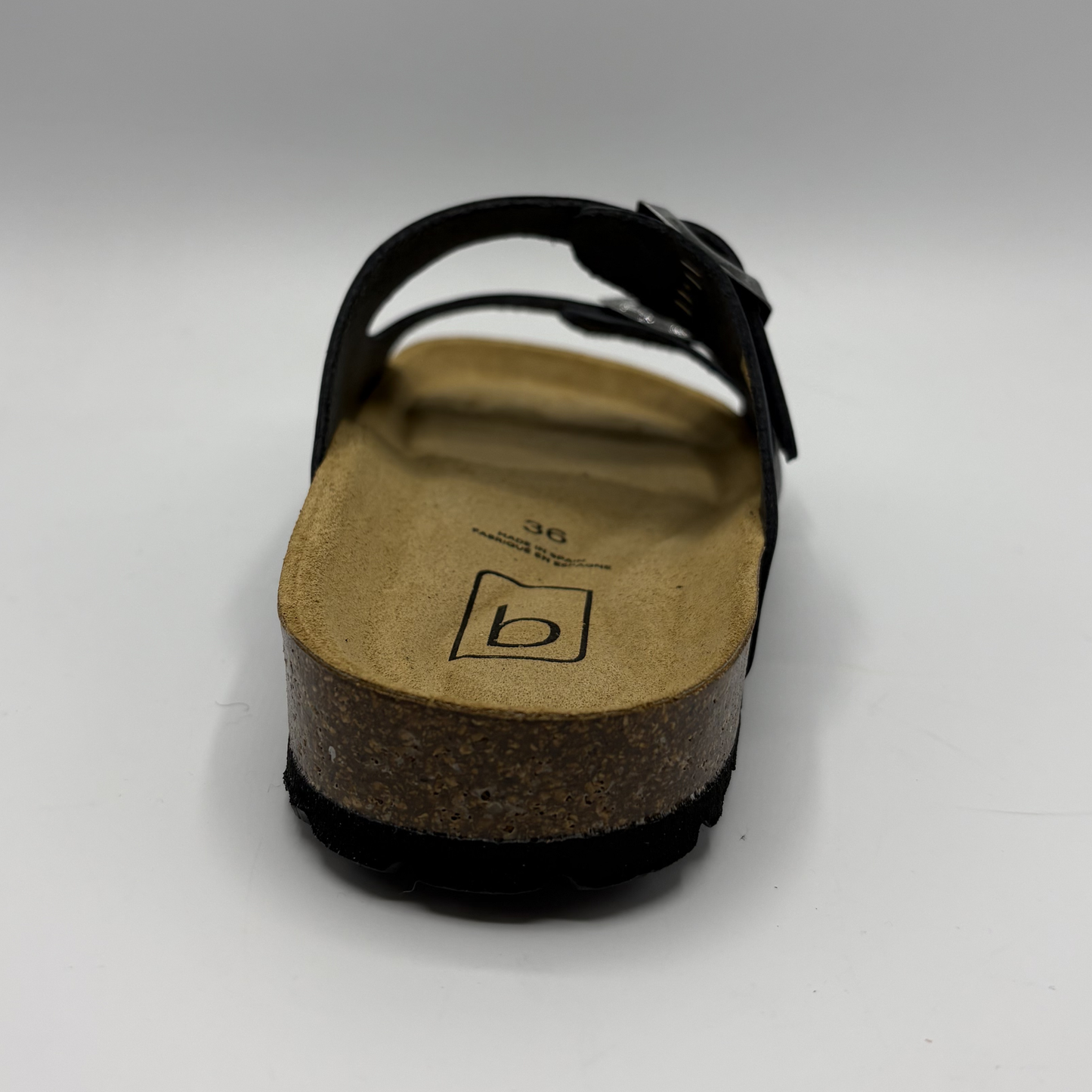 Black sandal with cork sole on a white background