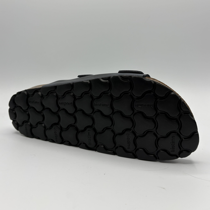 Black sandal sole on a gray background