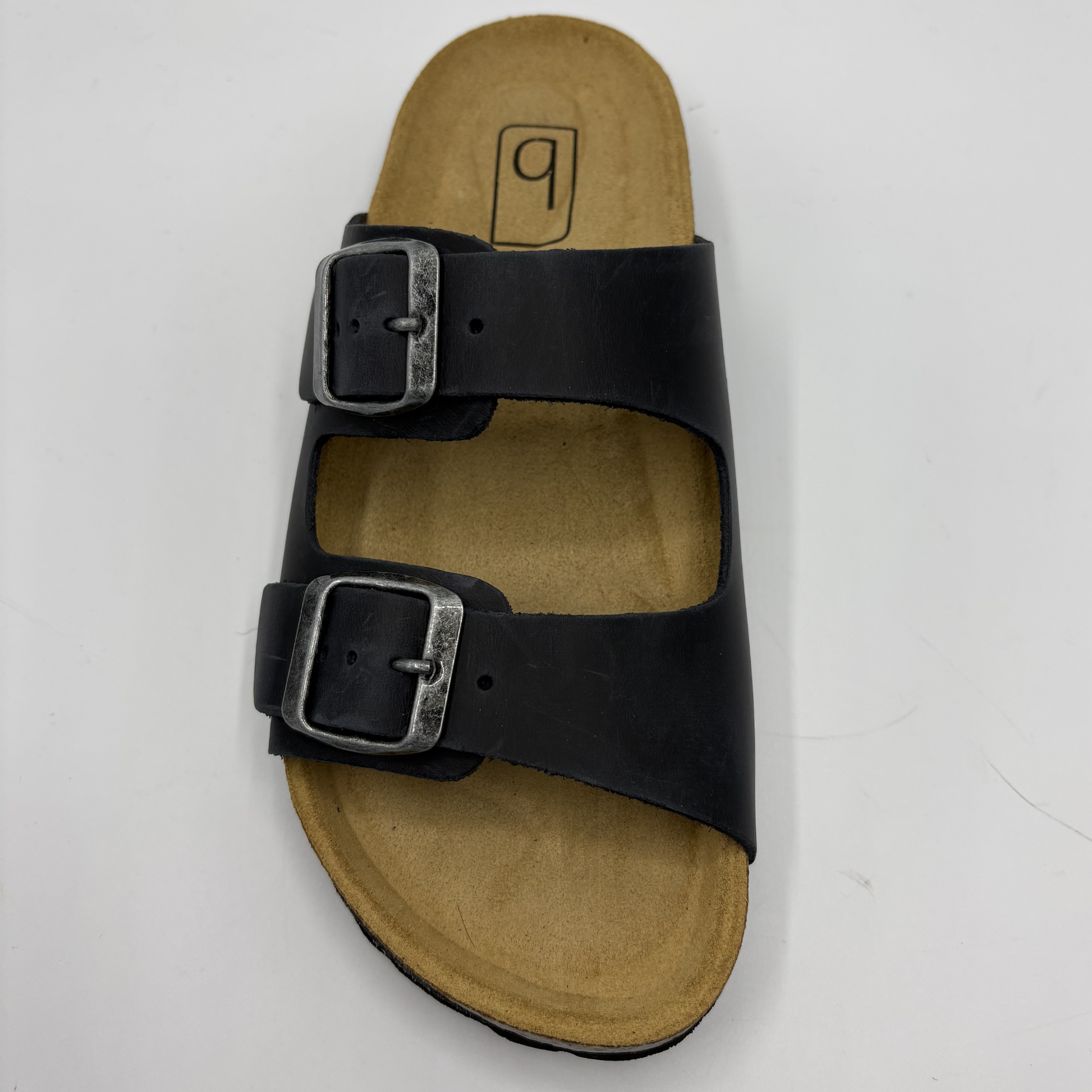 Black sandal with two buckles on a white background