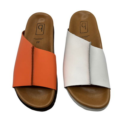 Top view of two slip on sandals beside each other. One has a peach coloured strap and the other one has a white. Both have a brown lined contoured footbed