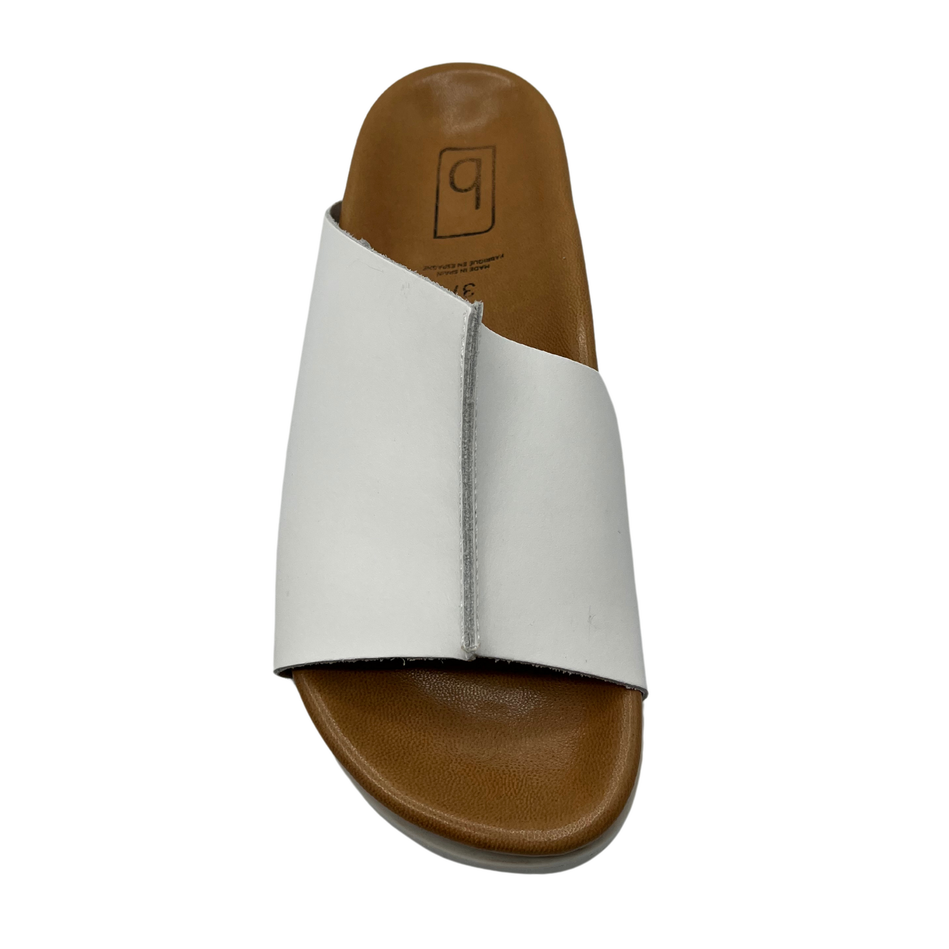 Top view of white leather slide on sandal with brown lined contoured footbed