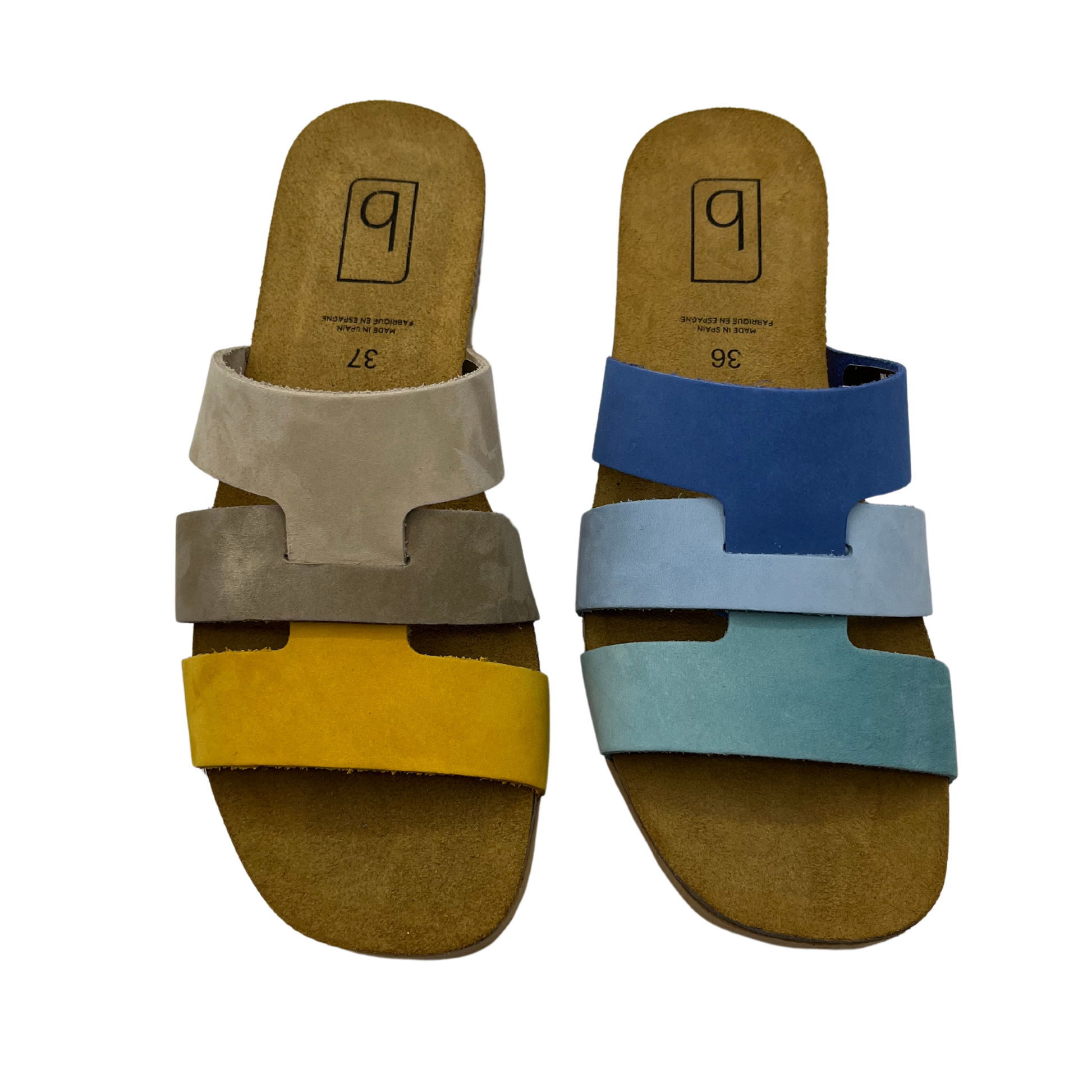 Top view of two suede slip on sandals. One is beige and yellow and the other one is 3 shades of blue. Tan suede lined with a rounded toe