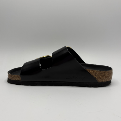 Black sandal with a cork sole on a gray background
