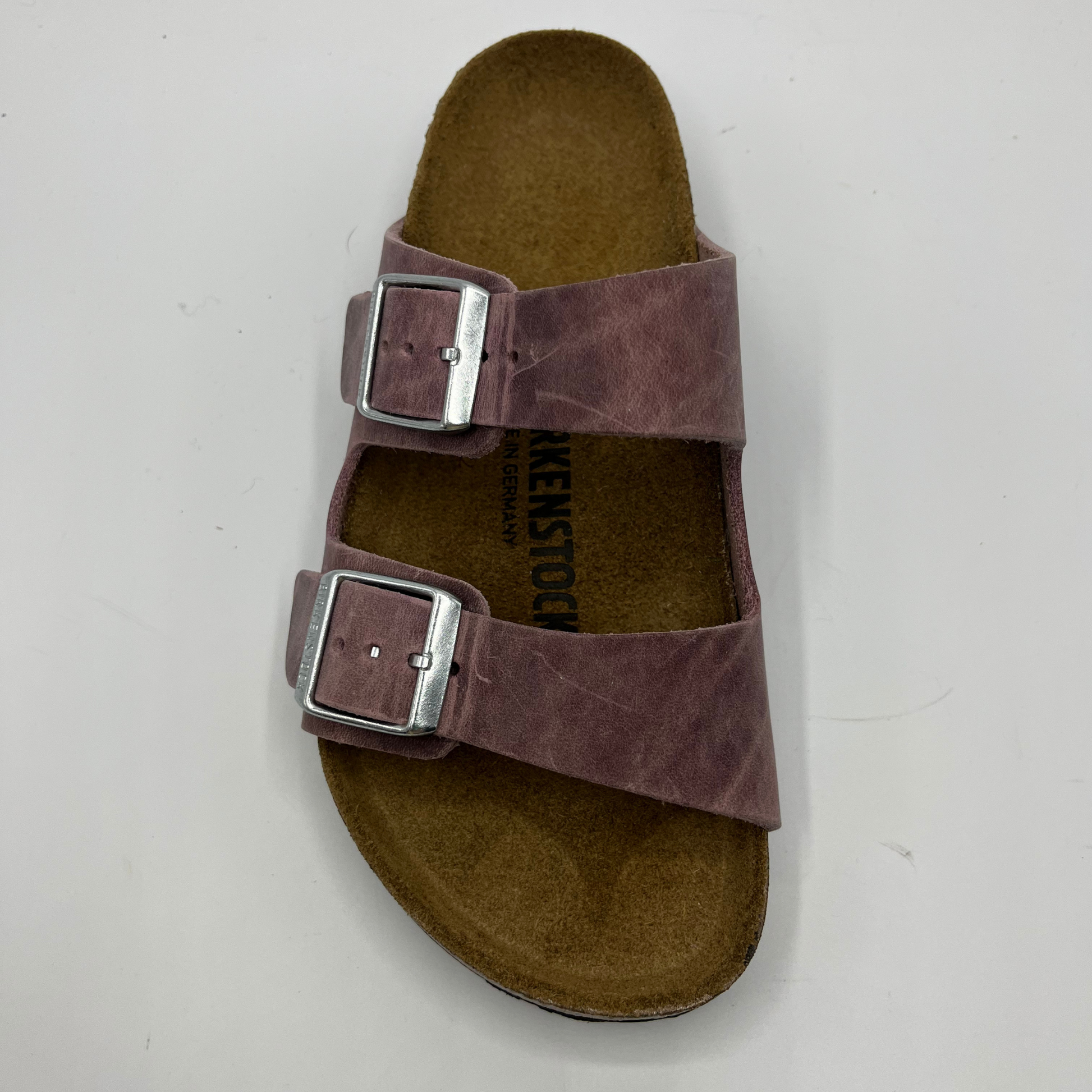 Top view of a lavender oiled leather sandal with a contoured cork footbed and two adjustable straps.