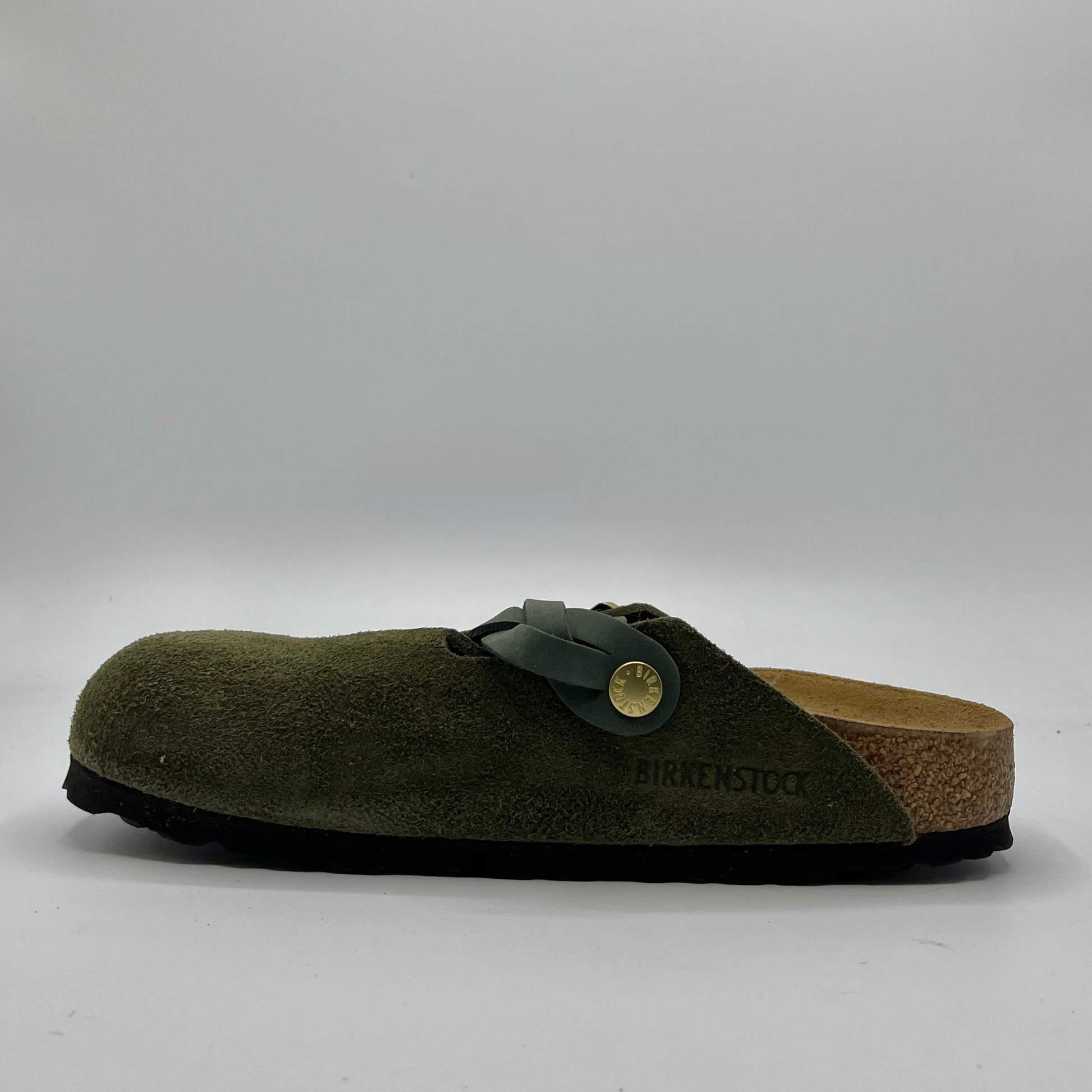 Green clog sandal with cork sole on a white background