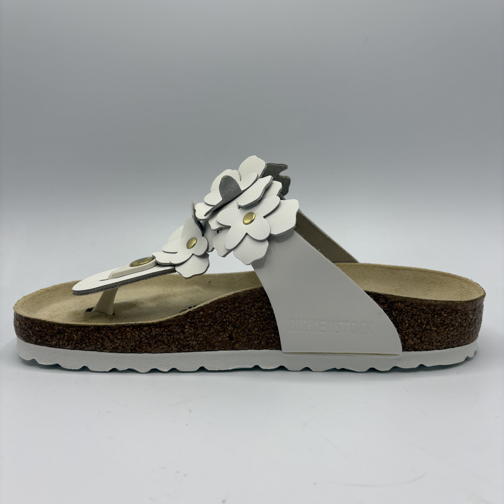 Birkenstock sandal with floral design on a gray background