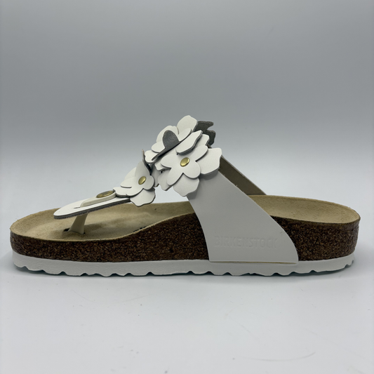 Birkenstock sandal with floral design on a gray background