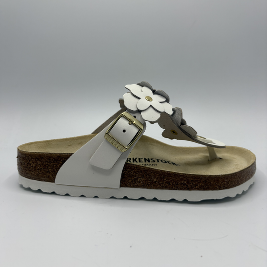 Birkenstock sandal with white flowers on a gray background