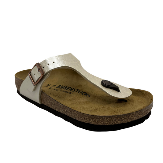 45 degree angled view of synthetic leather thong sandal with bronze buckle strap and suede lined contoured footbed.