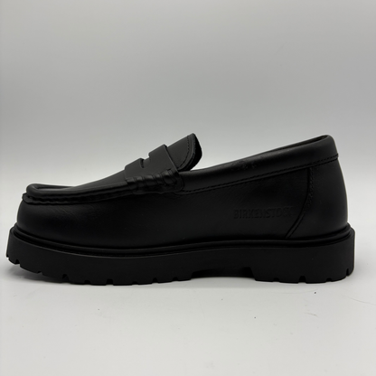 A single black leather loafer with a chunky lug sole, shown in a side profile view against a light gray background.