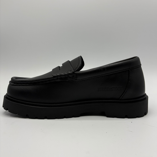 A single black leather loafer with a chunky lug sole, shown in a side profile view against a light gray background.