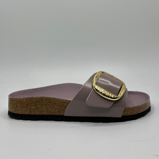 Right facing view of a faded purple slip on sandal with a big gold buckle on the strap. Featuring a lined,  contoured cork footbed