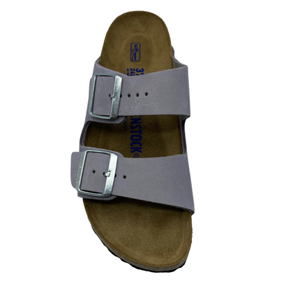 Top view of brown sandal with two lavender straps with silver buckles