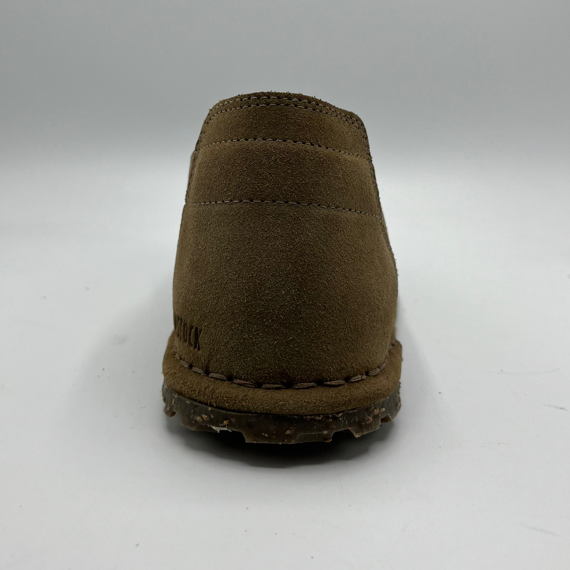 Brown suede shoe on a white background