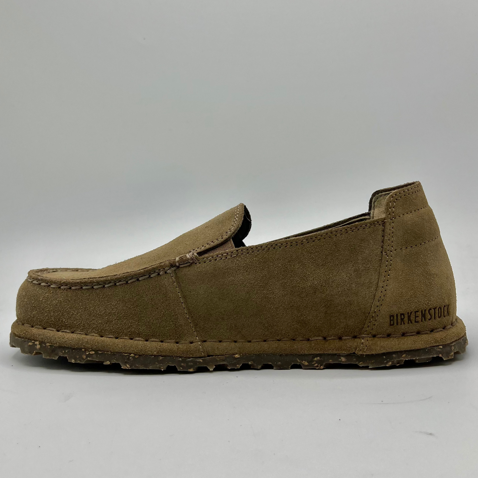 Brown suede loafer shoe on a white background