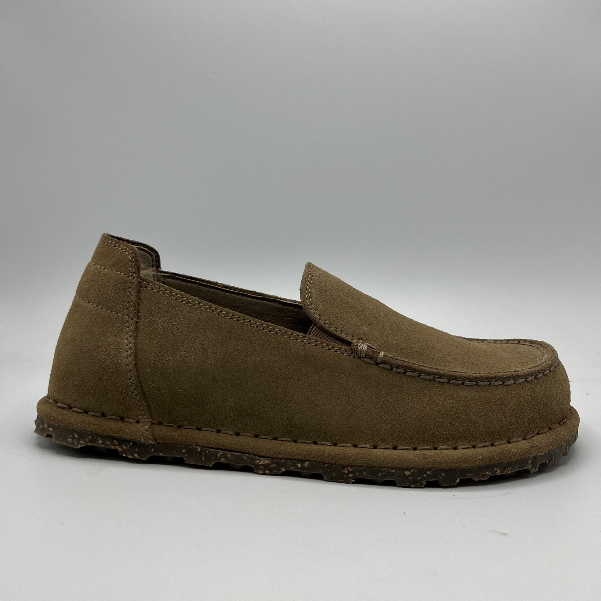 Brown loafer shoe on a gray background
