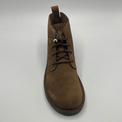 Brown suede boot on a white background