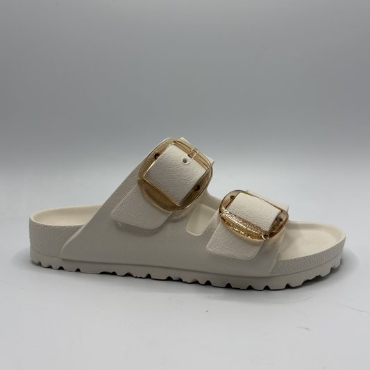 Eggshell sandal with gold buckles on a white background