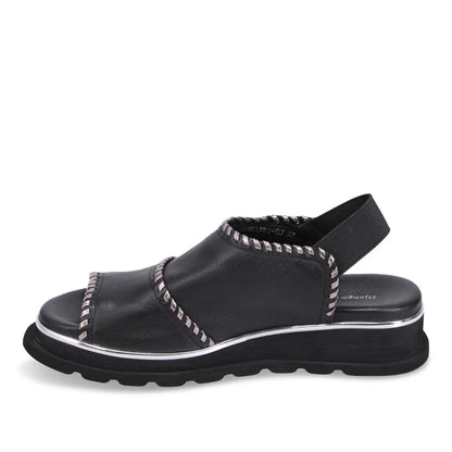 Inner side of Black Django & Juliette Carlenet sandal with metallic accents on a white background