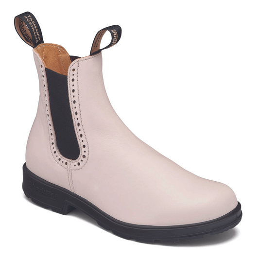 Angled view of pearl coloured leather ankle boot with black elastic side panel