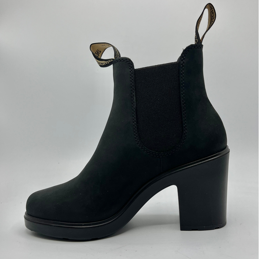 Black ankle boot with block heel on a light gray background