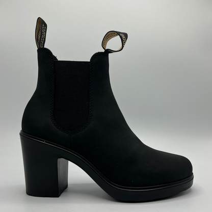 Black ankle boot with block heel on a light gray background