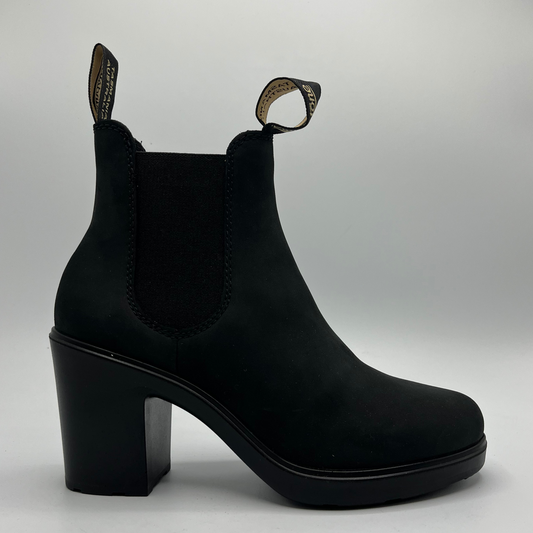 Black ankle boot with block heel on a light gray background