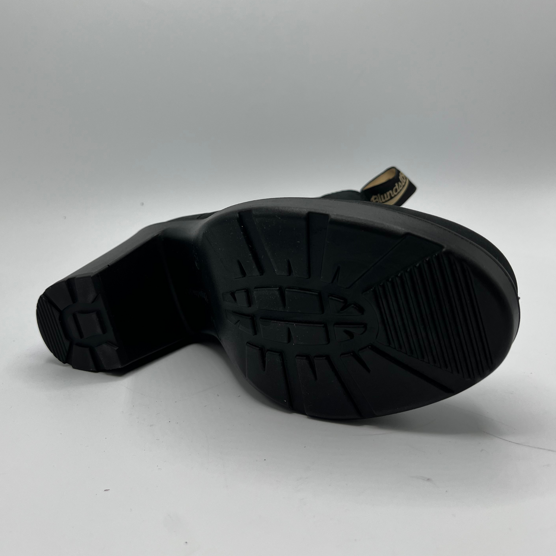 Black rubber sole of a boot on a white background