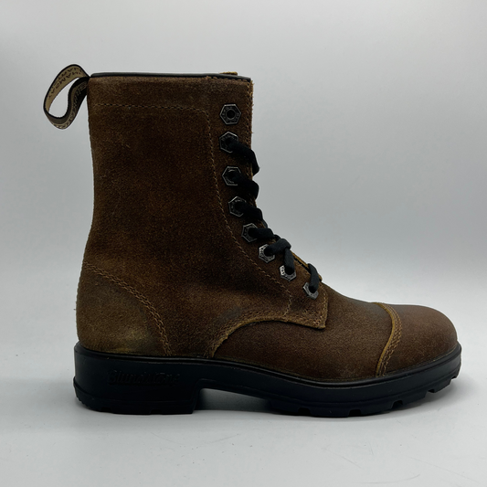 Brown leather boot with black sole on a light gray background