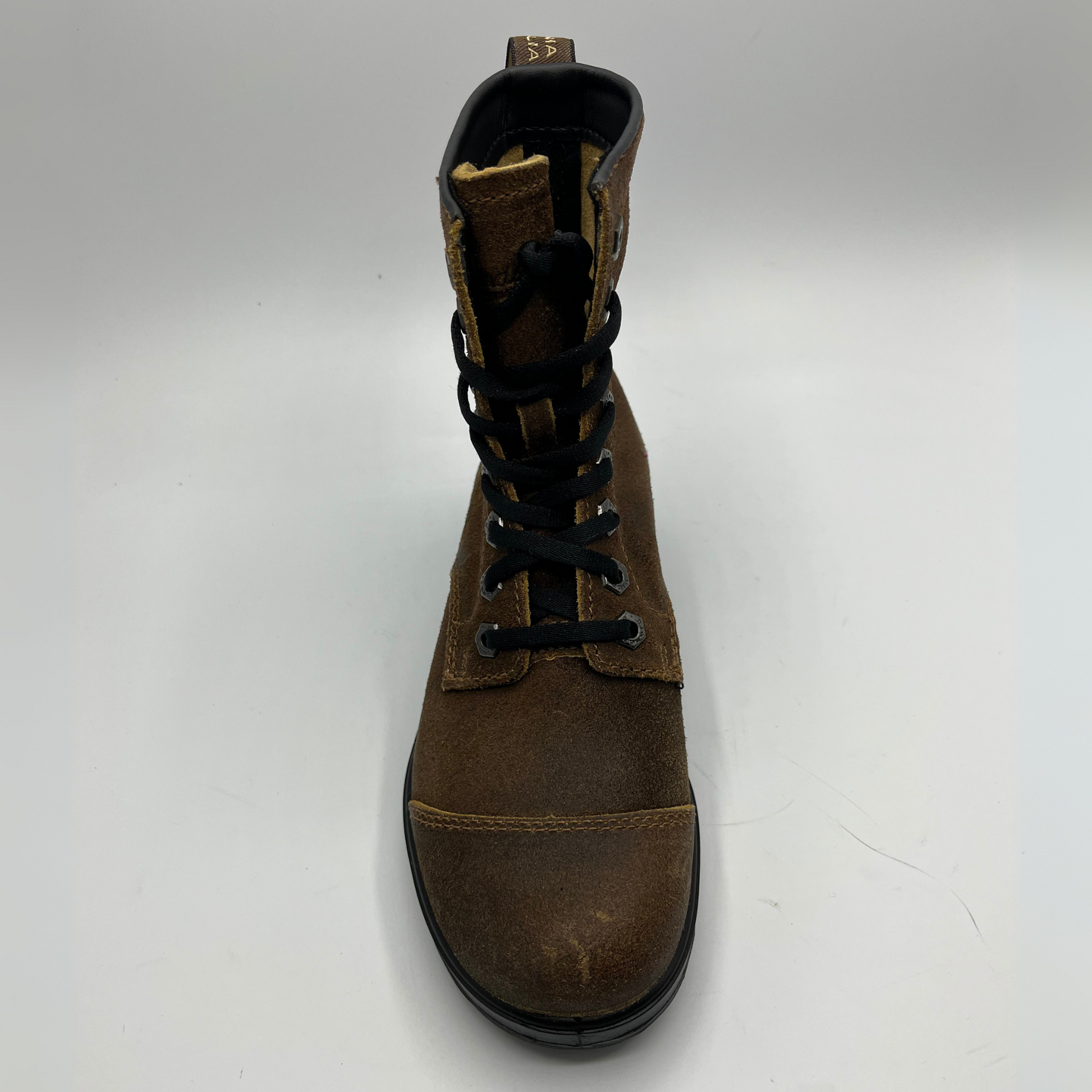 Brown leather boot with black laces on a white background