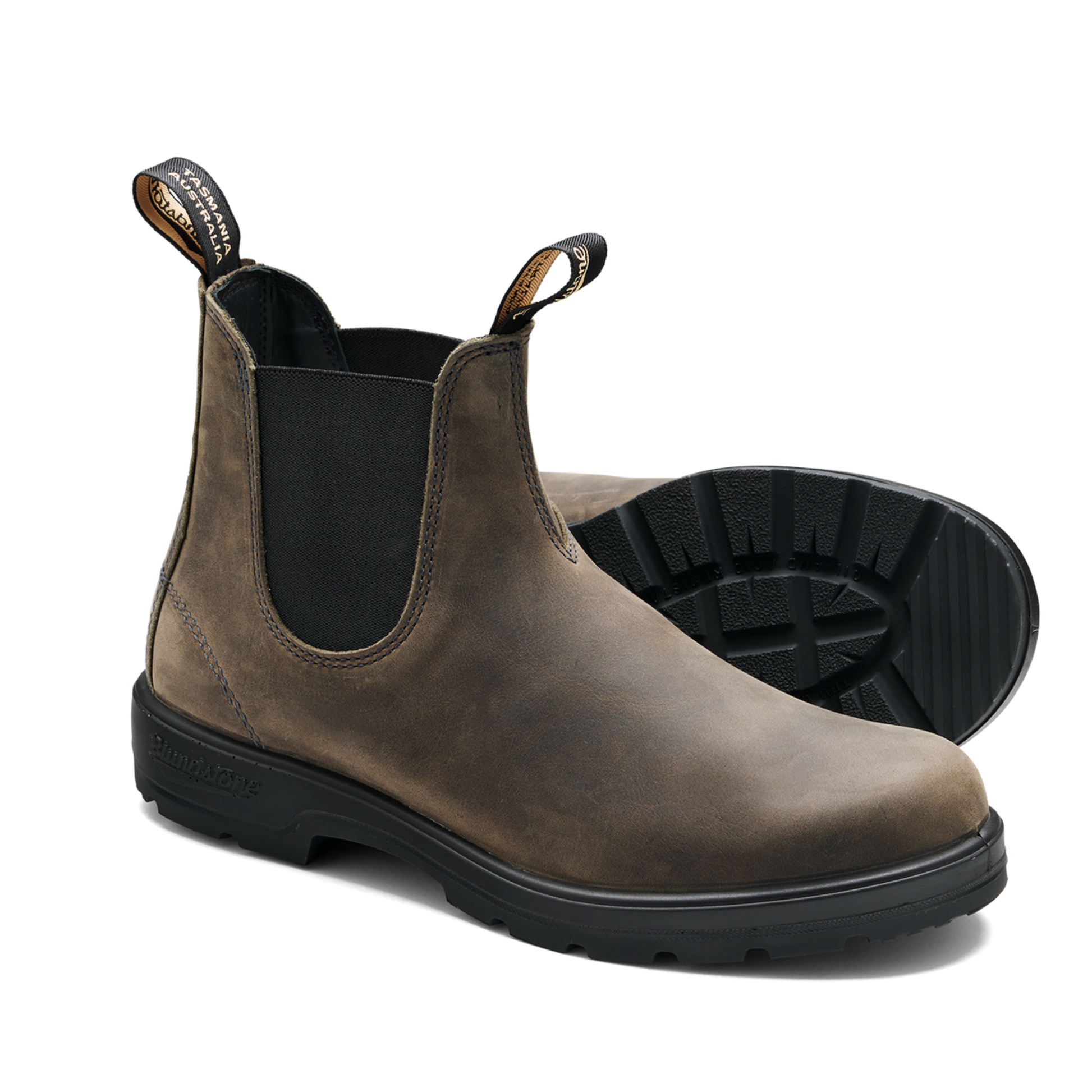 Brown Chelsea boot with black sole on a white background