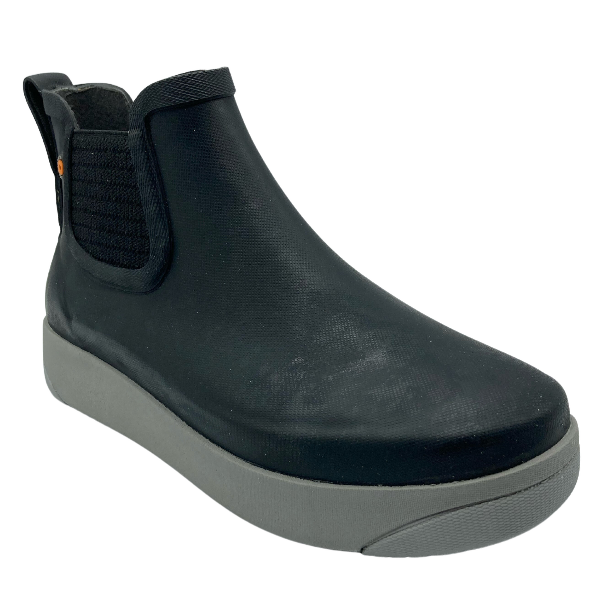 45 degree angled view of black short boot with grey rubber outsole and elastic side gore