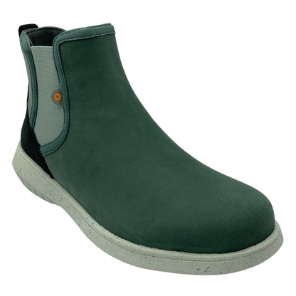 45 degree angled view of green leather short boot with white outsole and elastic side gore