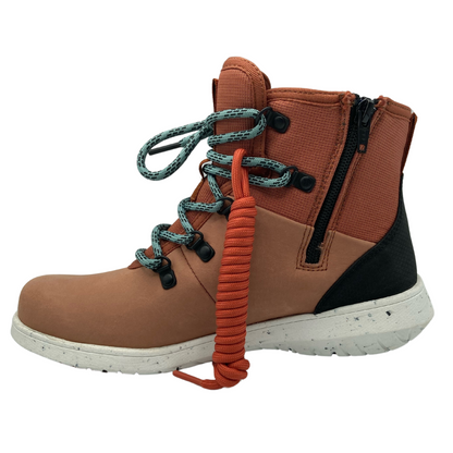 Left facing view of paprika coloured hiking boot with white outsole and teal laces.