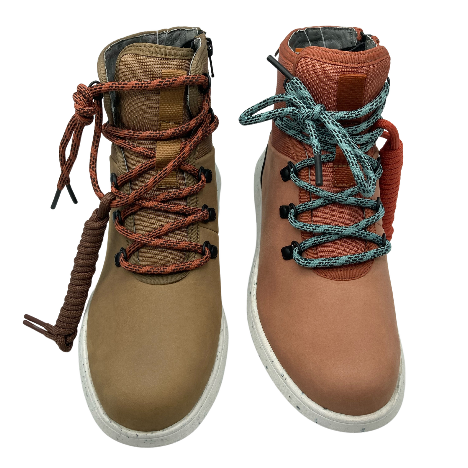 Top view of a pair of hiking boots, one light brown and one light orange. Both have white outsoles