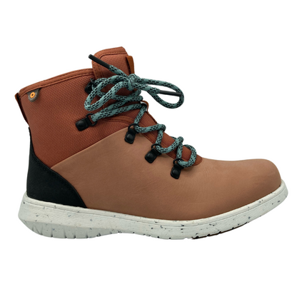 Right facing view of orange hiking boot with white outsole and teal laces
