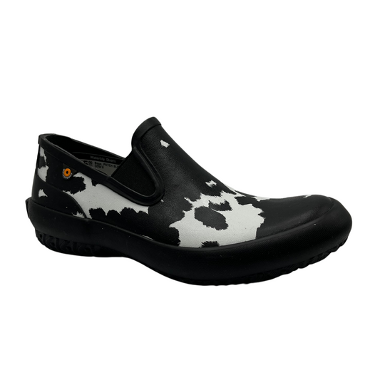 45 degree angled view of waterproof, cow print patterned slip on shoes