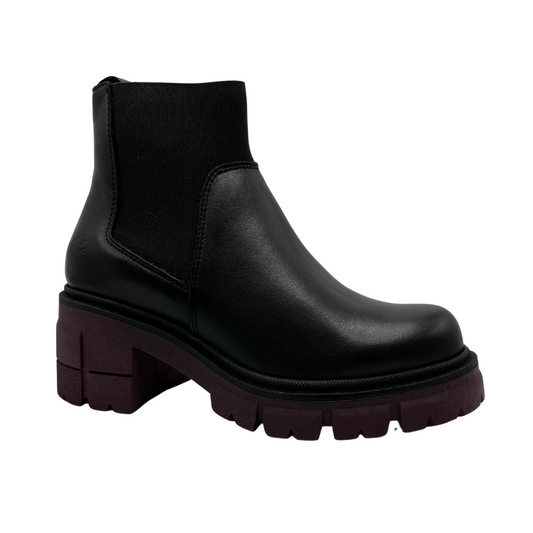 45 degree angled view of black leather boot with maroon coloured outsole and chunky heel. Elasticated ankle shaft.