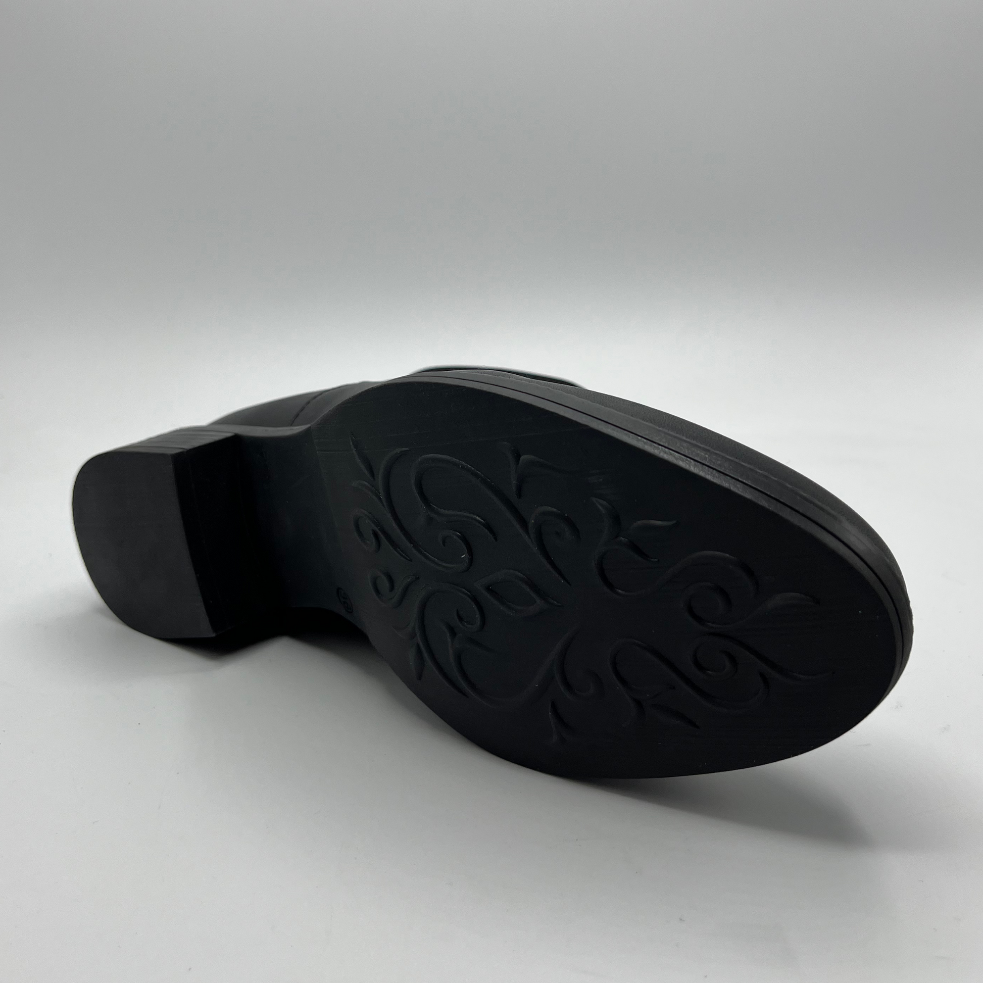 Black shoe sole on a gray background