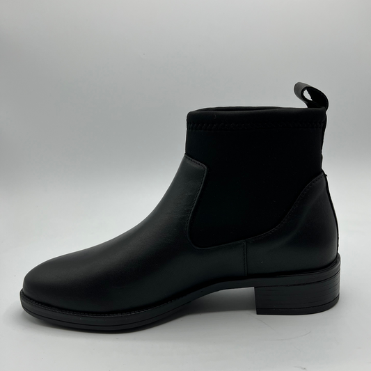 Black Chelsea boot on a light gray background