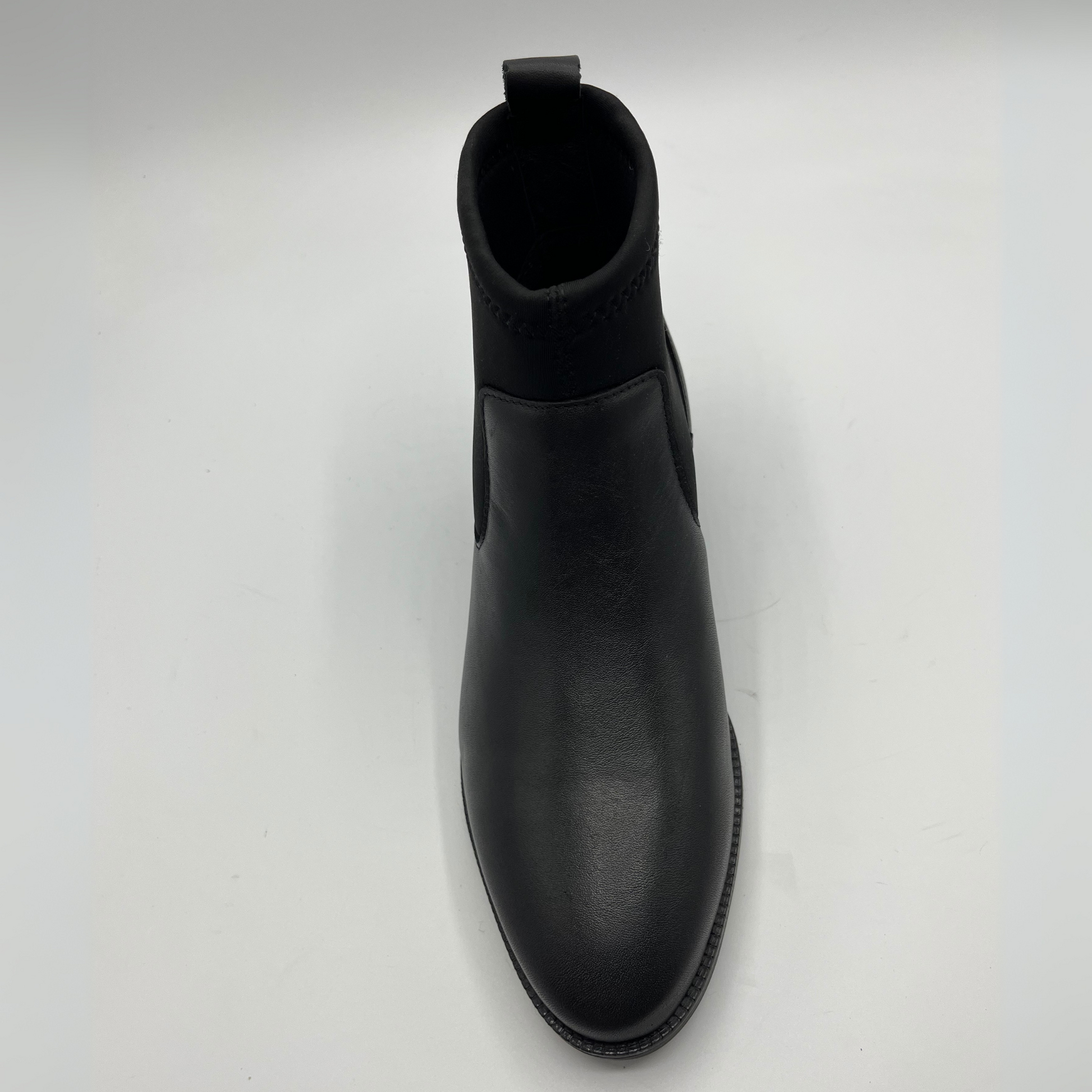 Black Chelsea boot on a white background